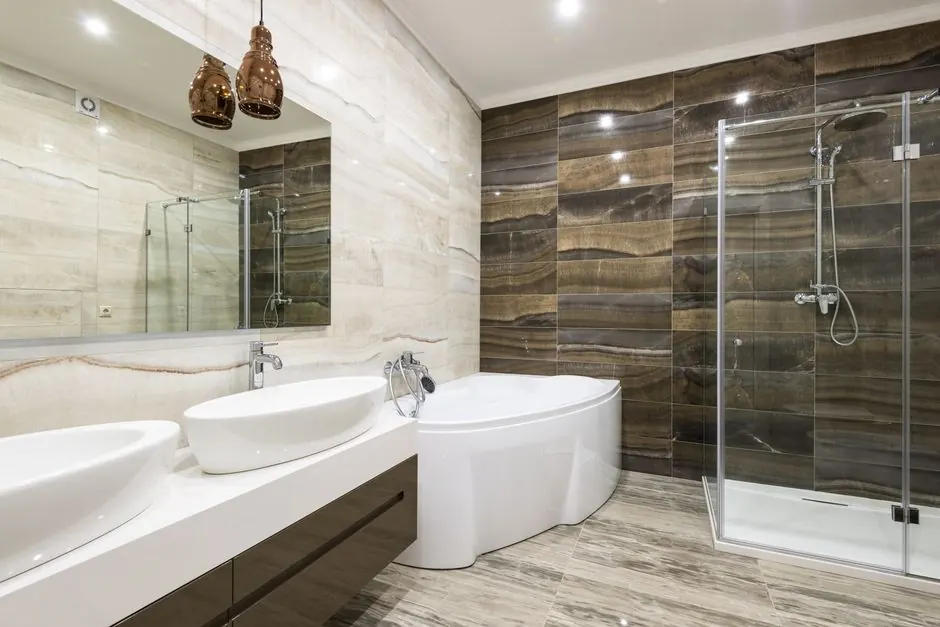 Bathroom with a corner bath, glass shower enclosure and twin basins