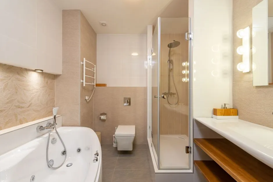Bathroom with a corner bath, glass shower cubicle and wall-hung toilet
